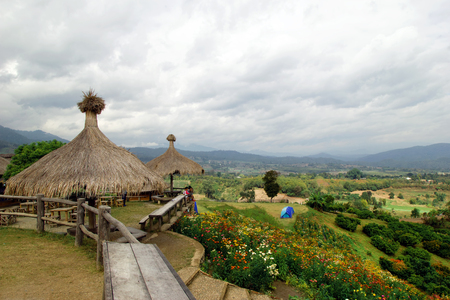 Scenic landscape on the mountains, small village, tents and a field of colorful chrysanthemums. Yun Lai, Pai, Thailand.のeditorial素材