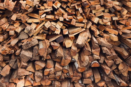Stacks of dry textured firewood closeup. Toned photo.