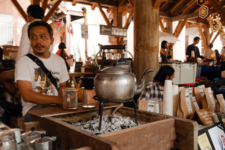 CHIANG MAI, THAILAND - DECEMBER 8, 2017: Vendor of coffee and coffee makers on a street market.のeditorial素材