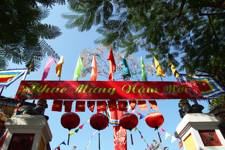 Hoi An, Vietnam - February 15, 2018: Festive colorful decorations on a building for celebrating Tet - Vietnamese New Year. The inscription is translated - Happy New Year.のeditorial素材