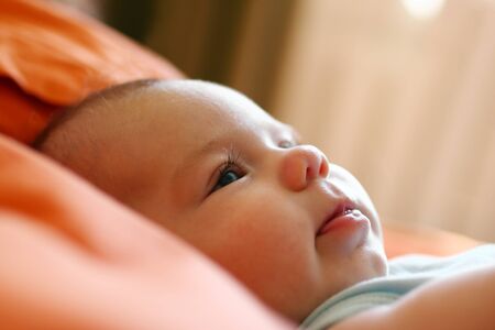 Portrait of child on a bed in a morning time in backlight.の写真素材