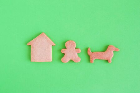 Homemade shortbread cookies on green background, top view. Man is walking with dog near house.