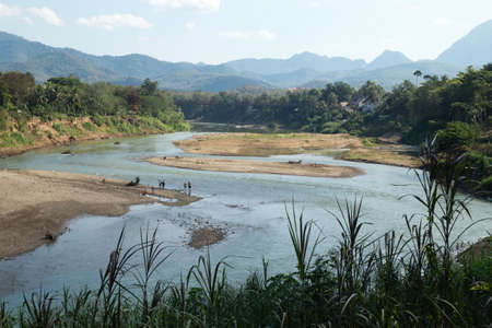 Luang Prabang, Laos - January 18, 2018: Aerial view from the hill on Mekong river, bridge and walking people.のeditorial素材