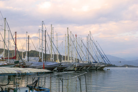 Fethiye, Turkey - December 8, 2022: Luxurious Yachts Moored in a Tranquil Harbor at Sunset, Boats...