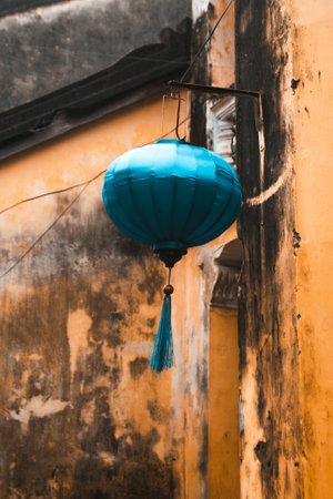 Stunning Blue Lantern Elegantly Hanging From a Charming Old Building in a Historic District.