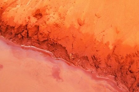 Abstract Landscape. Texture of Eroded Red Soil and Water Meeting. Mui Ne, Vietnam, Fairy Stream.の写真素材