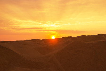 Golden Sunset Over Sand Dunes. Serene Desert Landscape with Warm Light. Mui Ne, Vietnam, Red Dunes.の写真素材
