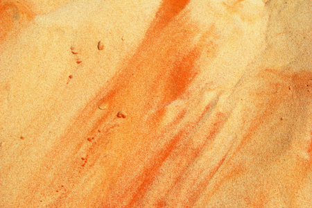 Textured Sand Surface with Warm Earthy Tones and Intricate Patterns.の写真素材