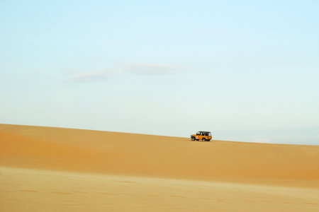 Adventure with Off-Road Vehicle Exploring a Vast Desert Landscape. Mui Ne, Vietnam, White Dunes.の写真素材