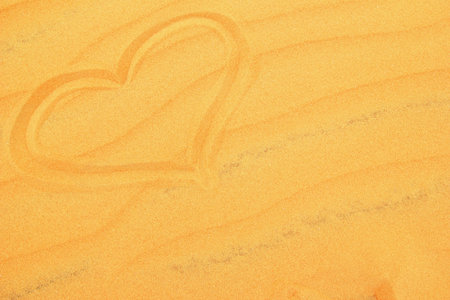 Heart Symbol Drawn on Sand Surface, Concept of Love, Romance and Valentine Day Theme.の写真素材