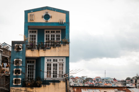 Charming Two-Story Blue Building with Balconies Overlooking a Picturesque Skyline. Dalat, Vietnam.の写真素材
