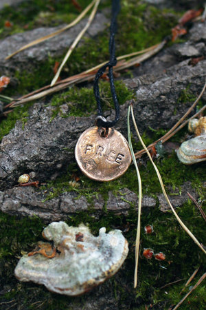 Rustic Bronze Pendant with Inscription Free on Mossy Tree. Symbol of Independence and Natural Beauty