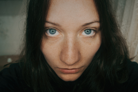 big blue eyes of girl looking at cameraの写真素材