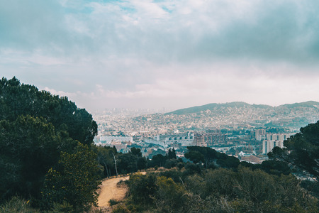 Views from collserola of the city of Barcelona on a cloudy dayの写真素材