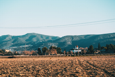 Cloudless landscape in an agricultural field in winter with a house isolated in the natureの写真素材