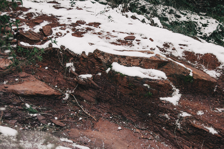 Semi-covered stones by snow in natureの写真素材