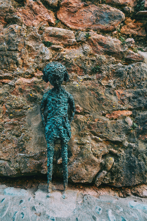 Stone statue of a girl on the street of a villageの写真素材