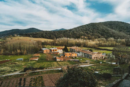 A view of some houses and farm fields from above in a rural landscapeの写真素材