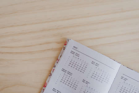 A 2021 diary on top of a light wooden desk ready for the new year