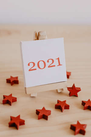 2021 written in brown on the canvas of an easel with dried brown fruits and flowers around it.の写真素材