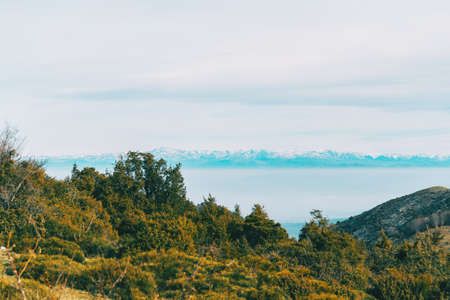 Landscape with views of a snowy mountain range in the distance