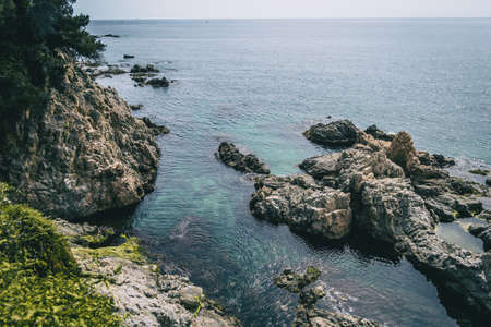 Seascape with some rocks on the water in Costa Bravaの写真素材