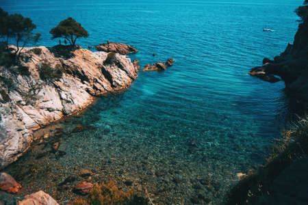 Seascape of a beautiful small cove with shallow crystalline waters on a sunny dayの写真素材
