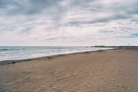Lonely beach in the delta del ebro, tarragona, spain. The day is cloudy and windy.の写真素材
