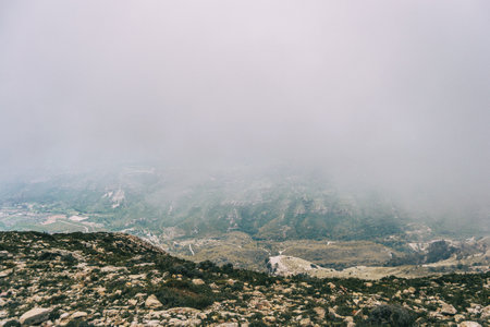 cloudy day with fog in the mountains of the natural park of the ports, in tarragona (spain). Photograph taken from a trail of the trekking pathの写真素材