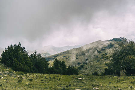 cloudy day with fog in the mountains of the natural park of the ports, in tarragona (spain). Photograph taken from a trail of the trekking pathの写真素材