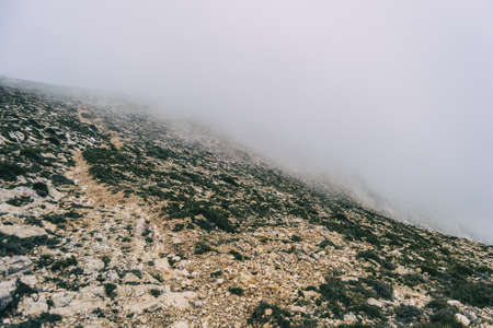 cloudy day with fog in the mountains of the natural park of the ports, in tarragona (spain). Photograph taken from a trail of the trekking pathの写真素材