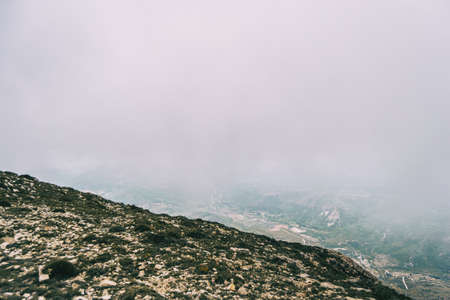 cloudy day with fog in the mountains of the natural park of the ports, in tarragona (spain). Photograph taken from a trail of the trekking pathの写真素材