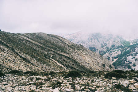 cloudy day with fog in the mountains of the natural park of the ports, in tarragona (spain). Photograph taken from a trail of the trekking pathの写真素材