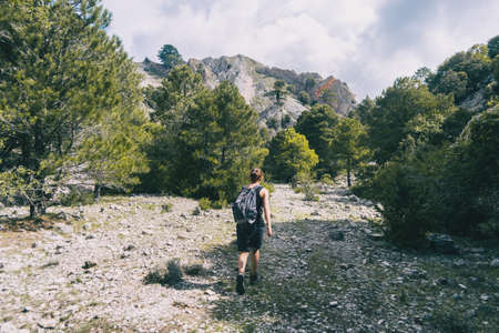 woman hiking on a mountain path in catalonia on a cloudy summer dayの写真素材