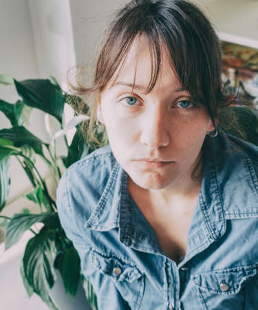 portrait of a girl with blue eyes and casual clothes looking at cameraの写真素材