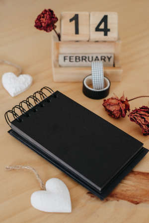 Wooden calendar on February 14 with roses and heart. happy valentines day conceptの写真素材