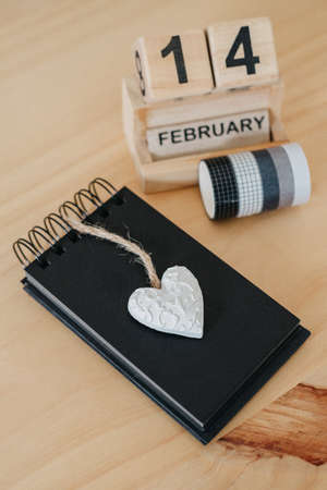 Wooden calendar on February 14 with a heart. happy valentines day conceptの写真素材