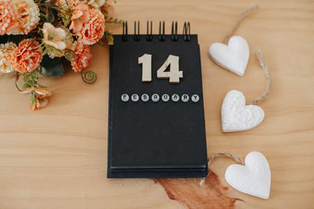 Wooden calendar on February 14 with roses and heart. happy valentines day conceptの写真素材