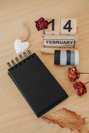 Wooden calendar on February 14 with roses and heart. happy valentines day conceptの写真素材