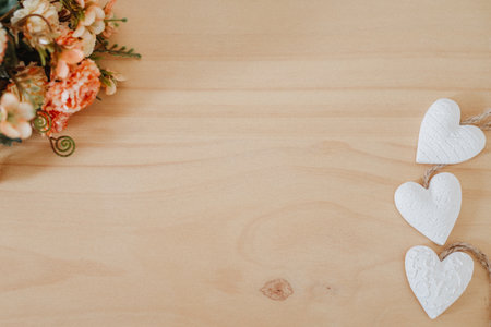 wooden table with a bouquet of flowers and a white heartの写真素材