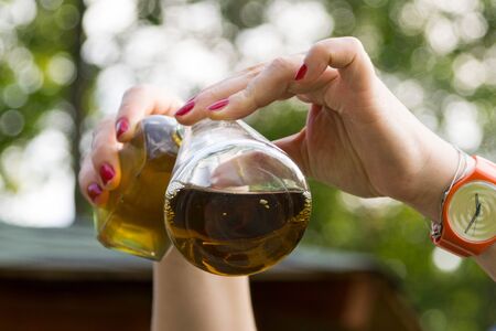 Chemical experiment: pouring liquid from a bottle into a flask