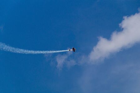 Single-seat aerobatic aircraft performs tricks in the skyの写真素材