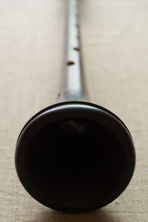 Trumpet of a folk wooden wind reed musical instrument shawm (schalmei, schalmeien) close-up