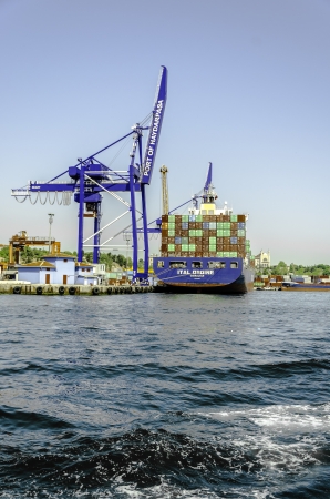 Cranes and cargo containers at Haydarpasa port   Istanbul  Ä°STANBUL, TURKEY  May 18, 2013-Container Cranes and Containers at HaydarpaÅa port   Ä°stanbul  Passenger Ship passing in fron of the HaydarpaÅa portのeditorial素材