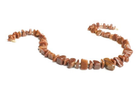 Brown agate necklace made from different pieces. Isolated on whiteの写真素材