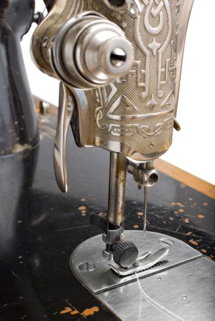 Close-up to old sewing machine isolated on white