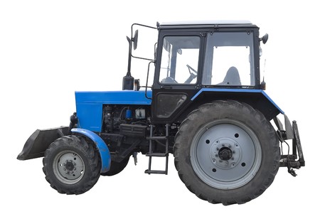 Blue medium agricultural tractor after the several years of usage. Isolated on white backgroundの写真素材