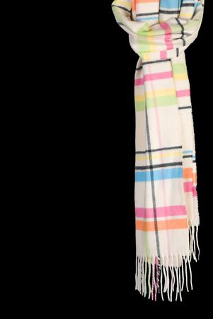 Multicolored winter scarf. Isolated on black backgroundの写真素材