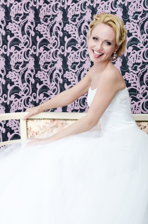20s aged young adult bride is sitting on a bench  She is smiling and put out her tongue の写真素材