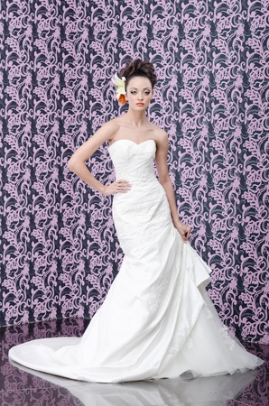 Pretty young adult bride with make up and lily flowers in hairの写真素材